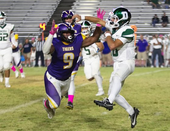 Lemoore's Trevon Gaffney puts pressure on Dinuba's quarterback in big 49-12 victory over the visiting Emperors.